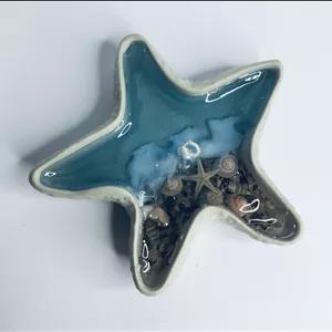 شمع فانتزی طرح دریا با ظرف ستاره دریایی سنگی و پارافین ژله ای دست ساز